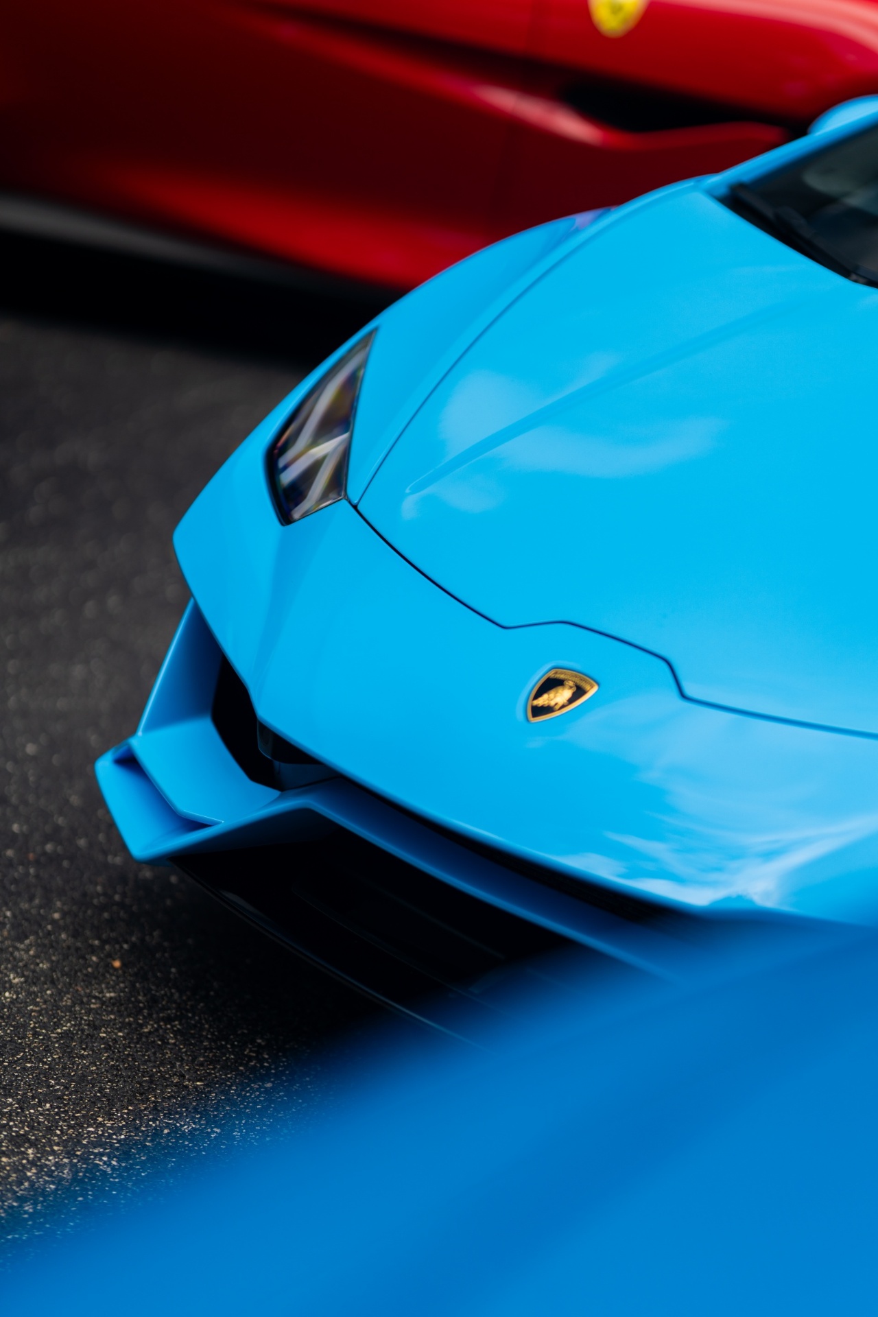 Baby blue Lamborghini Huracan with red Ferrari